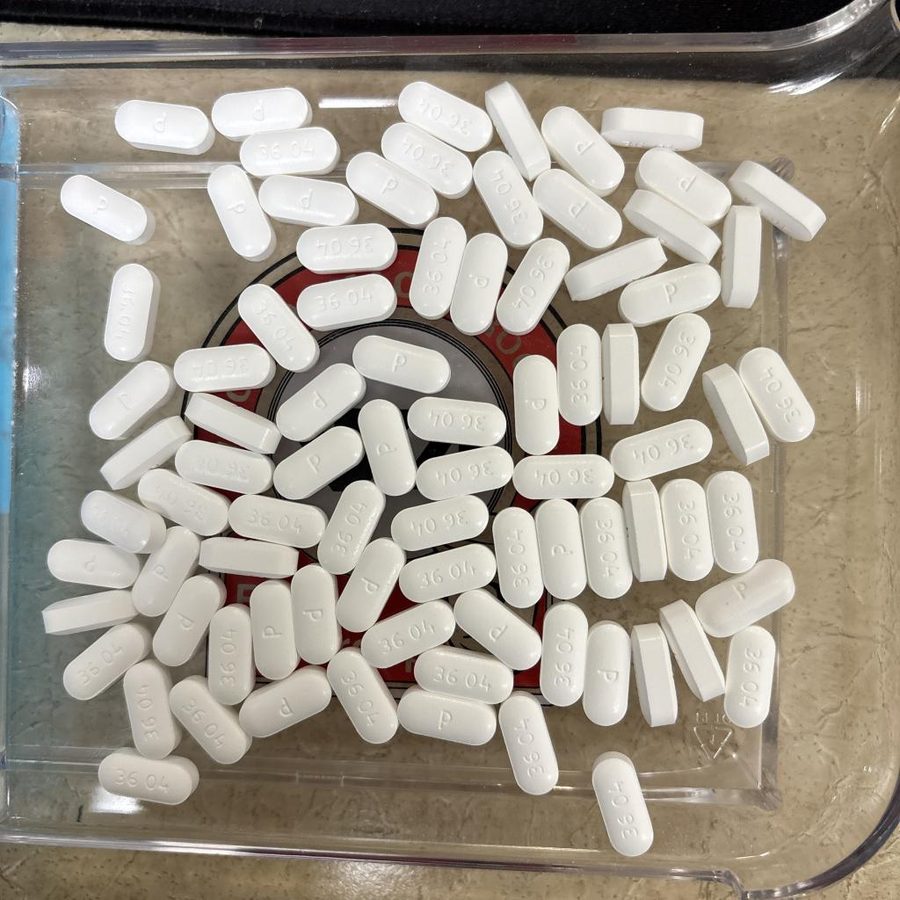 White caplets heaped in a mound on a tray