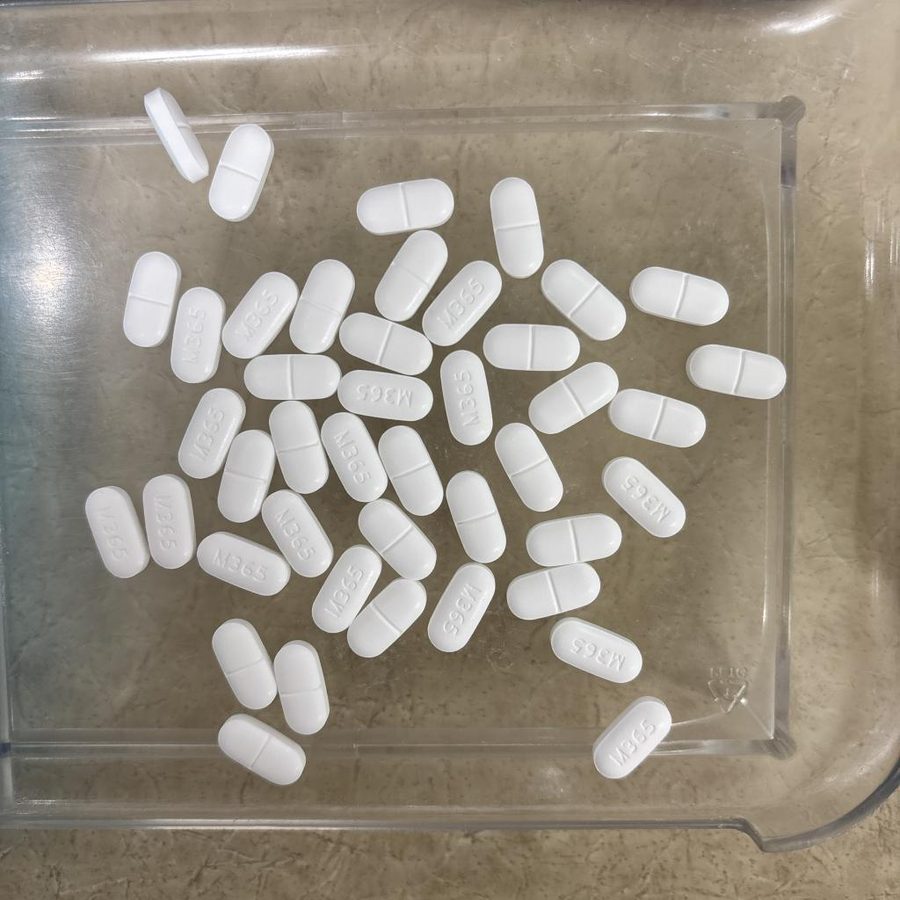 Forty-three white oblong caplets on a counting tray
